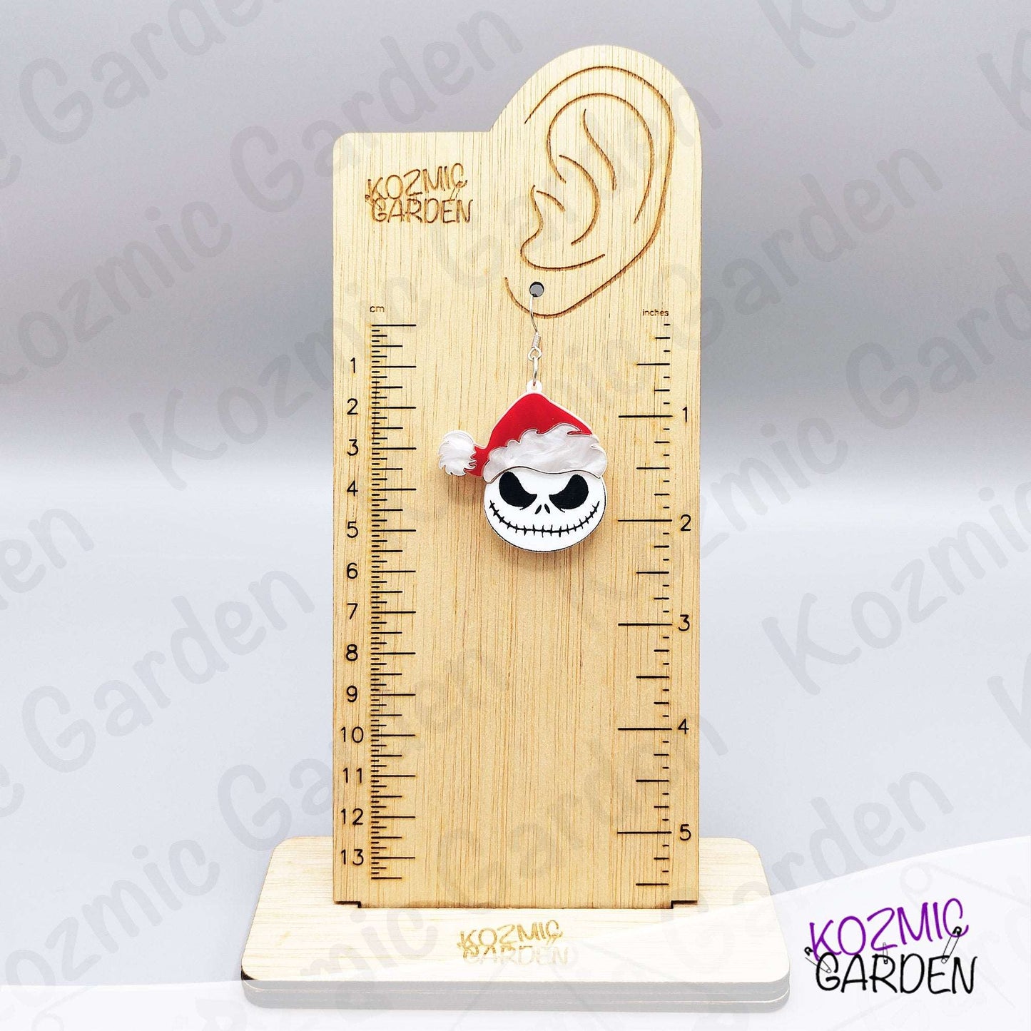 Spooky Christmas earrings worn on ear. Fun gothic holiday accessory for fans of dark, alternative fashion and Halloween lovers.