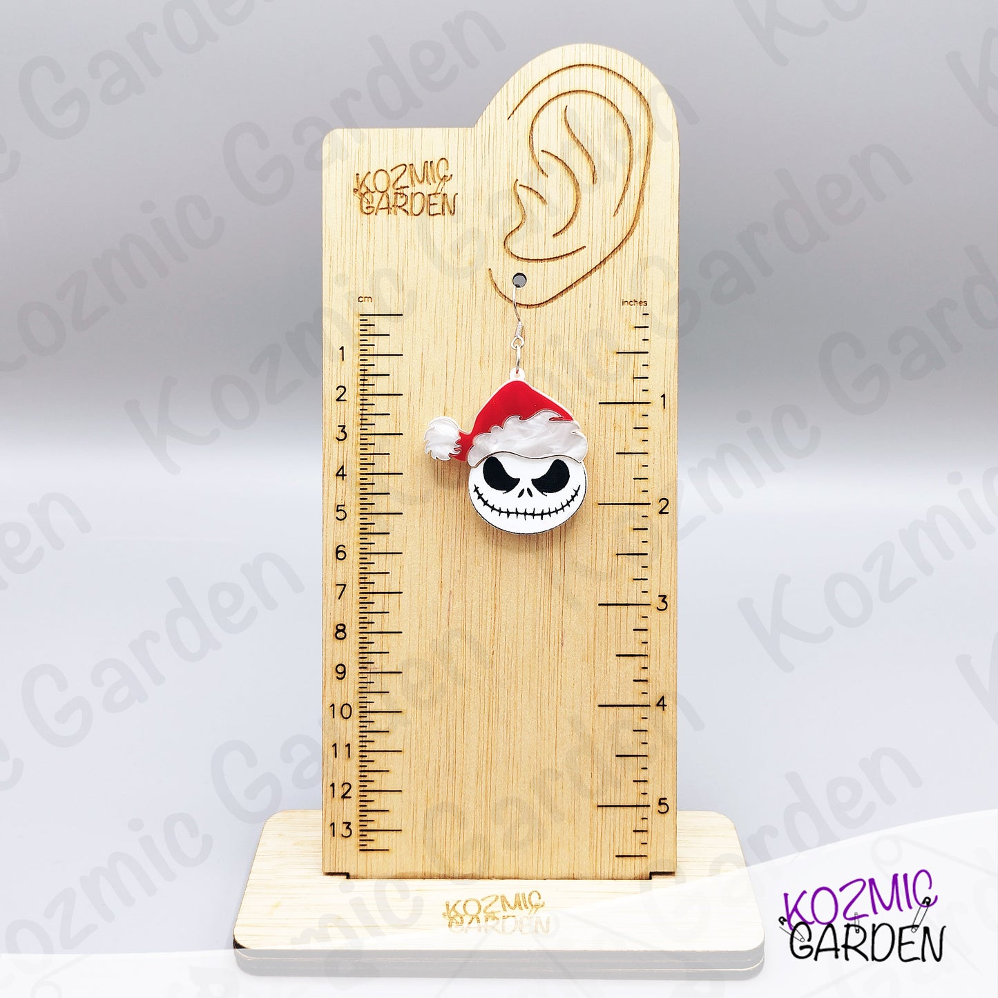 Spooky Christmas earrings worn on ear. Fun gothic holiday accessory for fans of dark, alternative fashion and Halloween lovers.