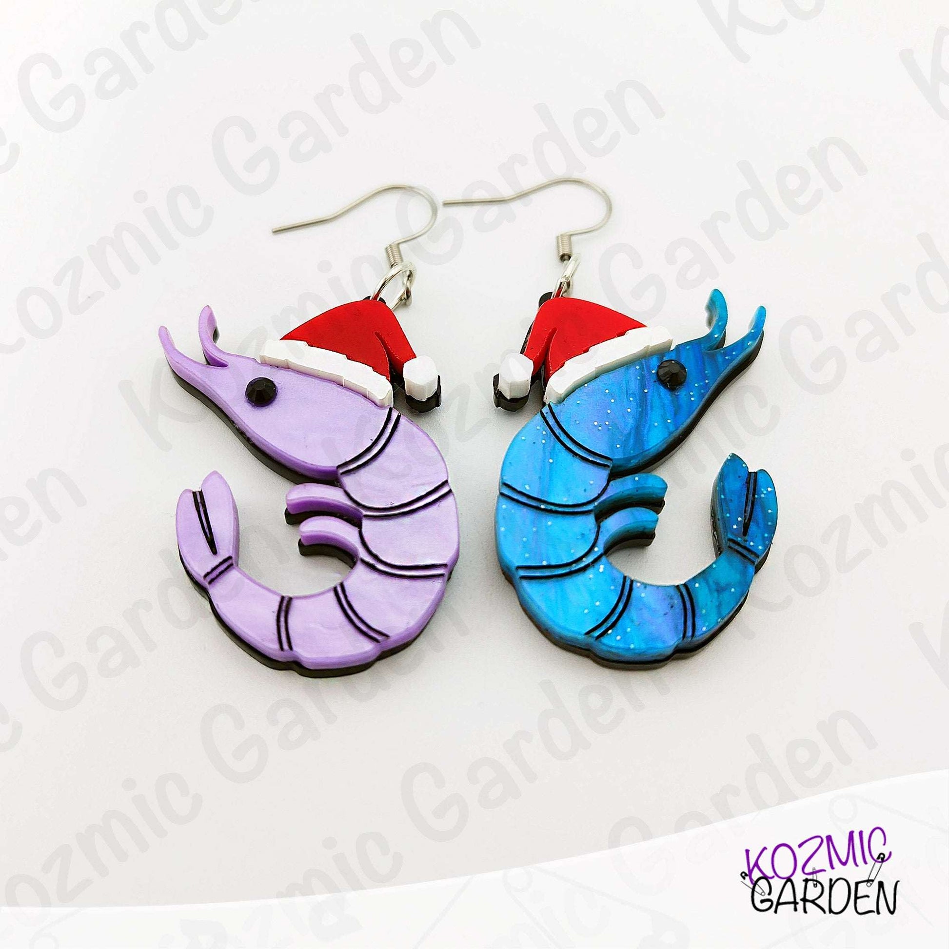 Shrimp-shaped earrings with red hats on a white background with 'Kozmic Garden' branding.