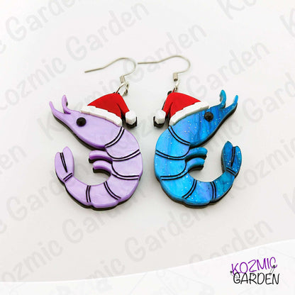 Shrimp-shaped earrings with red hats on a white background with 'Kozmic Garden' branding.