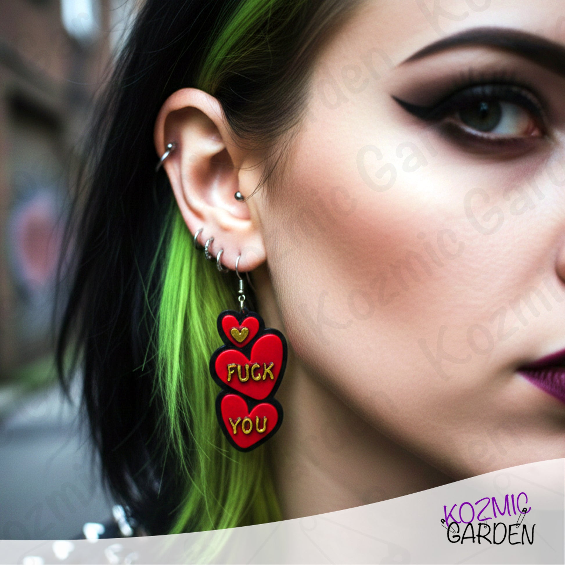 Close-up of a person wearing earrings with red hearts and text, with 'Kozmic Garden' branding.