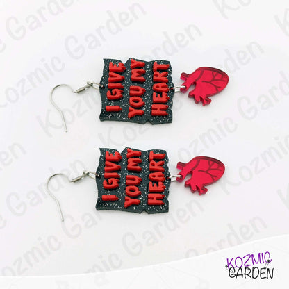 Pair of earrings with 'I Give You My Heart' text and red heart shapes on a white background.