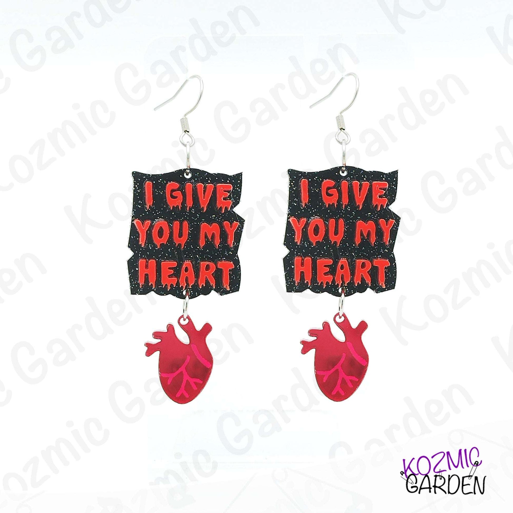 Earrings with 'I Give You My Heart' text and red heart design on a white background with brand name.