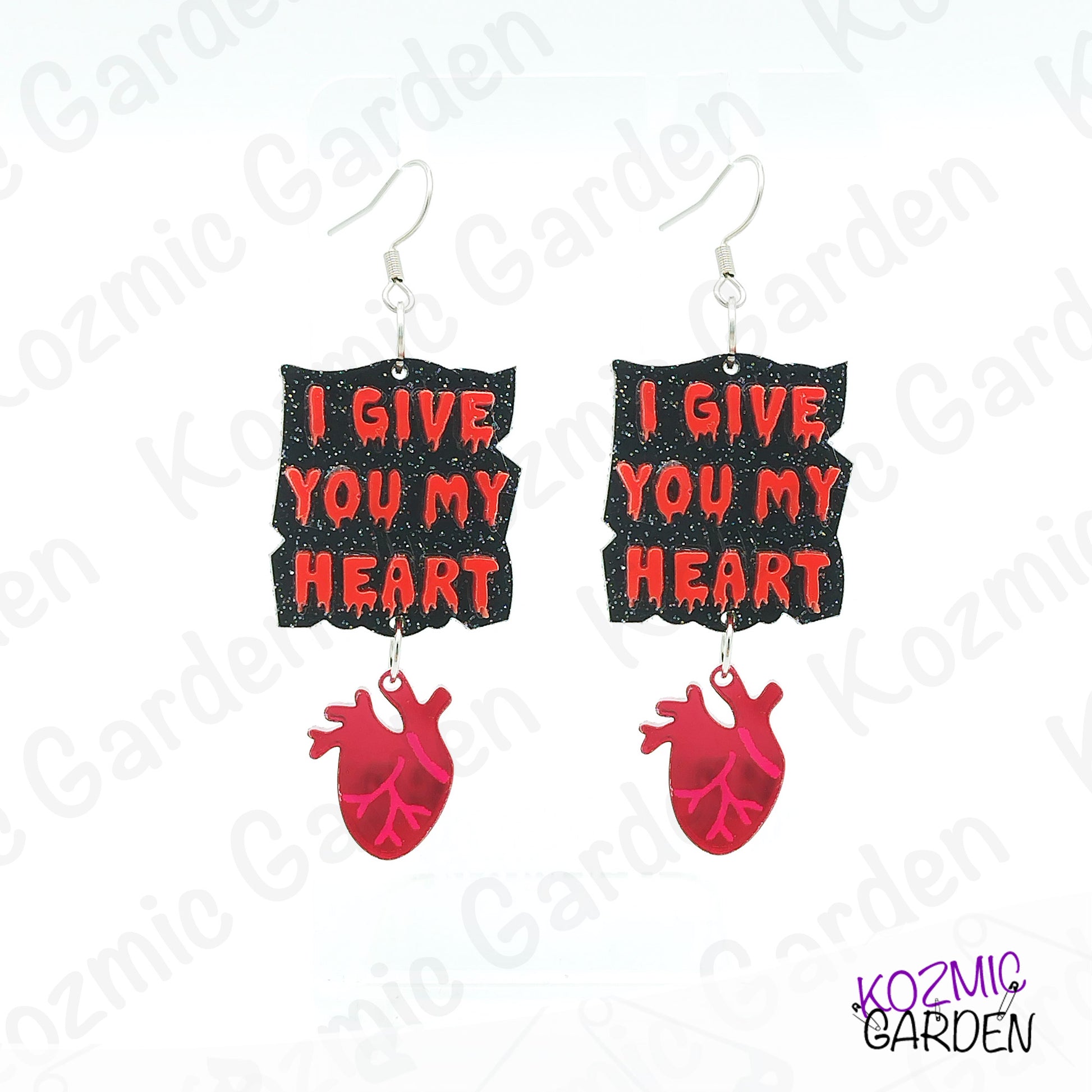 Earrings with 'I Give You My Heart' text and red heart design on a white background with brand name.