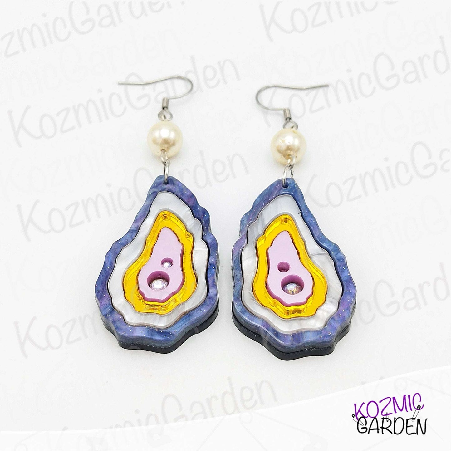 Elegant pearl drop earrings with ocean-inspired oyster shell design