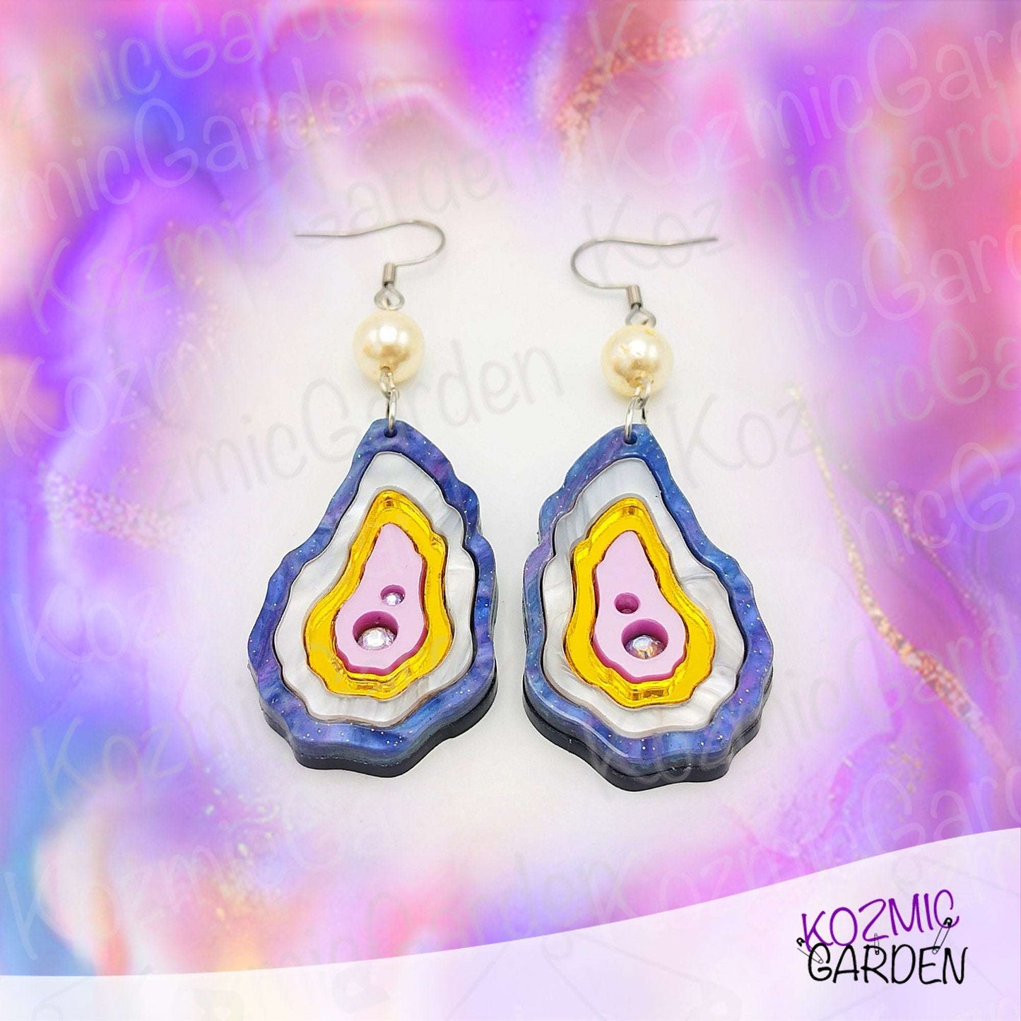 Layered seashell earrings in purplish, pearl, gold, and rose tones