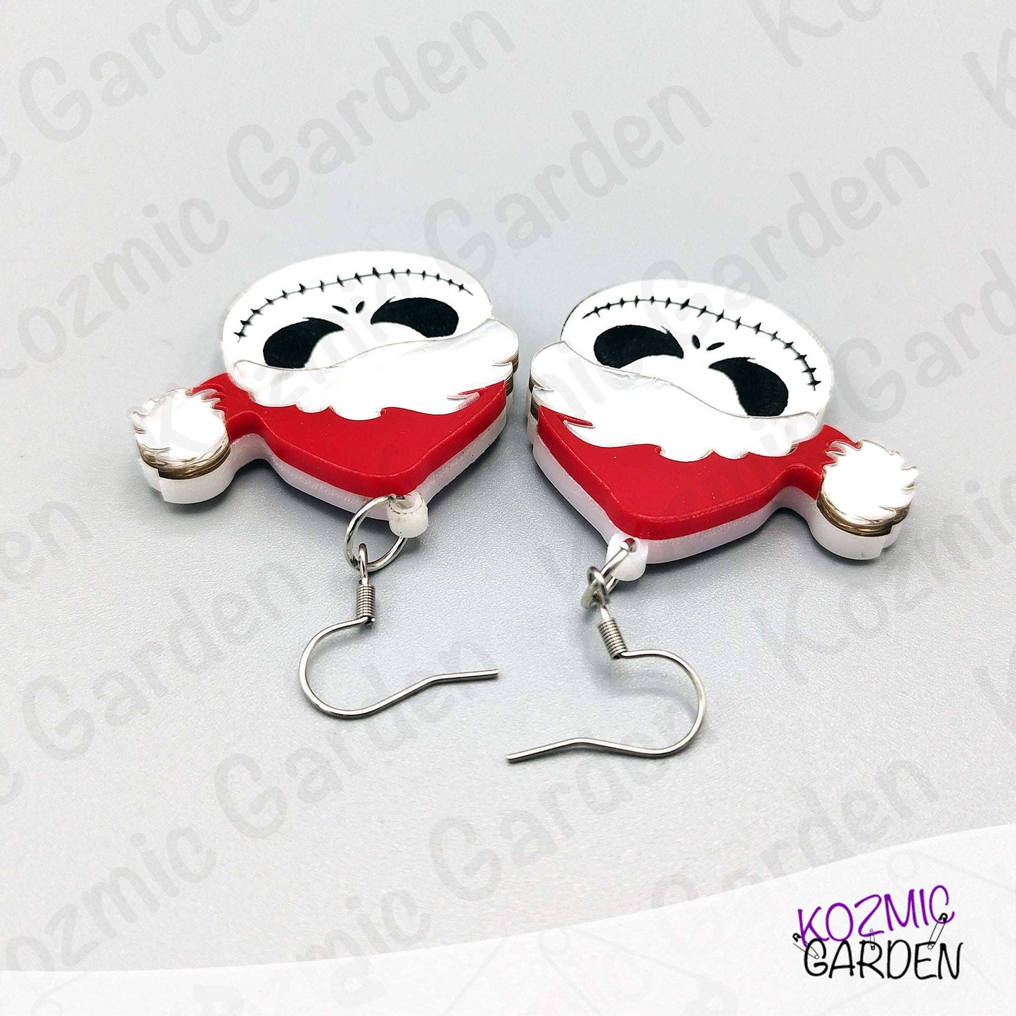 Jack Skellington Santa hat earrings shown beside a ruler for scale. Perfect small statement earrings with comfortable, everyday wear sizing.
