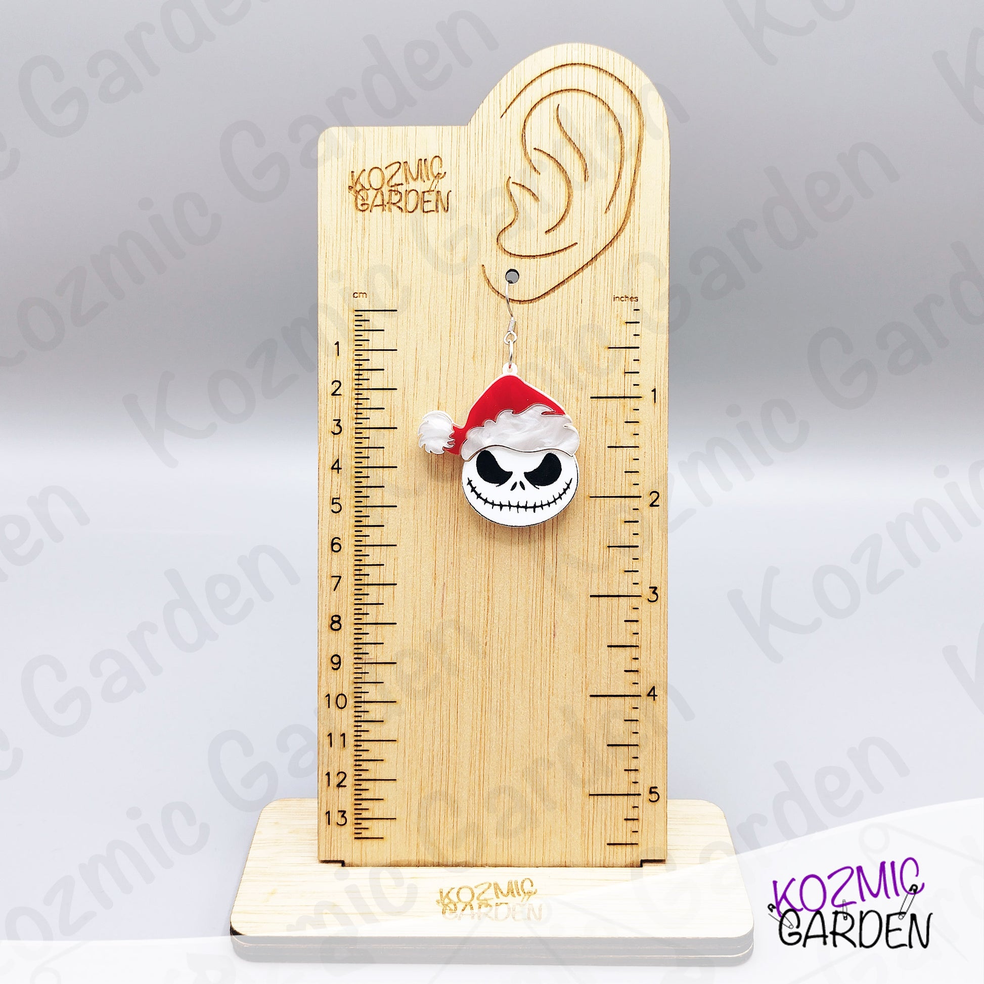 Spooky Christmas earrings worn on ear. Fun gothic holiday accessory for fans of dark, alternative fashion and Halloween lovers.
